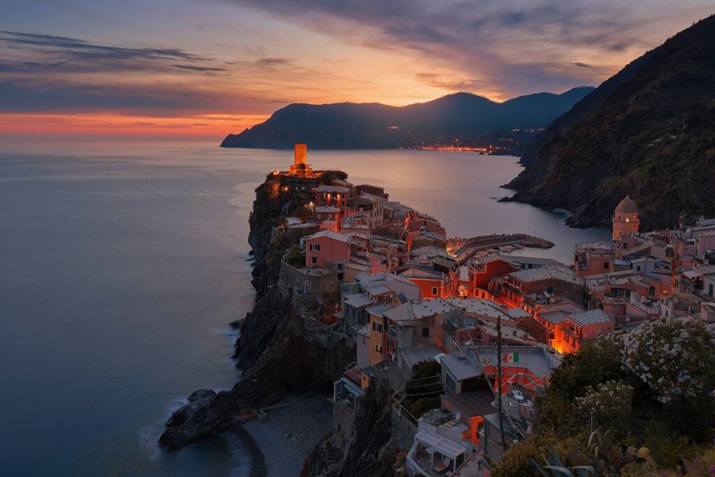 The coastal village of Vernazza in Italy under a warm orange sky